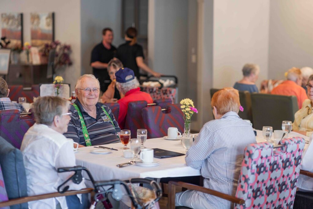 GC6A6814 - Pointe at Meridian Residents sharing a meal in the dining room at The Pointe at Meridian, a welcoming community for independent living.