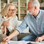 April 25 Events Page Image - Pointe at Meridian Elderly man and woman smiling and holding small dog