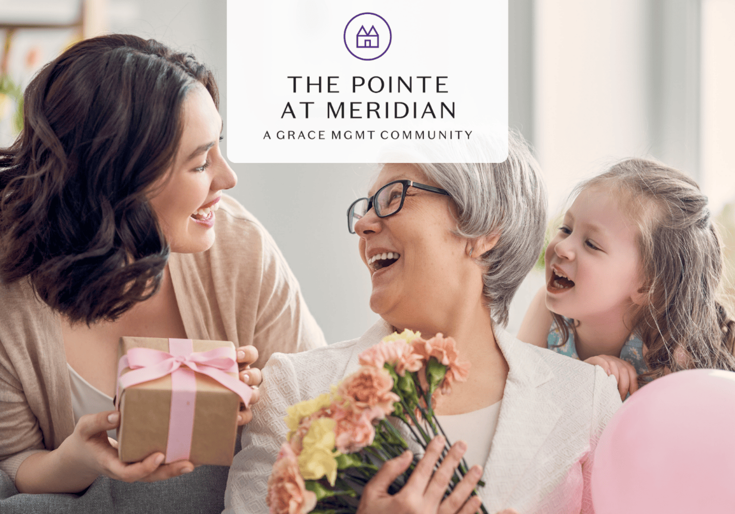 Three generations celebrate together: a young woman offers a gift to an older woman who holds flowers, with a child smiling nearby and a logo above.
